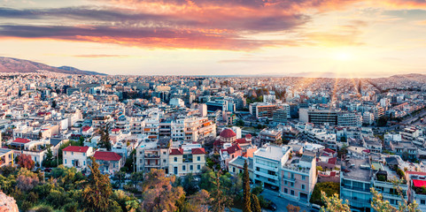 Fototapeta na wymiar Colorful evening view of Athens, capital of Greece, Europe. Fantastic spring sunset in the big sity. Traveling concept background. Artistic style post processed photo.