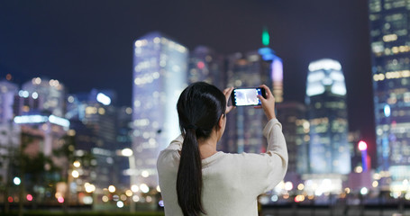 Woman take photo with cellphone in Hong kong