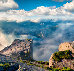 Misty morning view of popular Norwegian attraction Preikestolen. Great summer scene of the...
