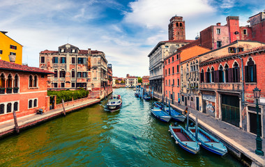 Fototapeta premium Beautiful spring view of Vennice with famous water canal and colorful houses. Splendid morning scene in Italy, Europe. Magnificent Mediterranean cityscape. Traveling concept background.