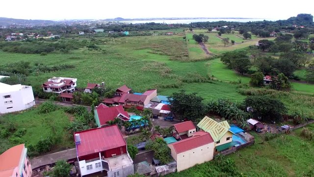 Los Ba&ntilde;os, Laguna, Philippines - November 21, 2017: Modern housing community at the foot of mountain rainforest. Drone Aerial Shot