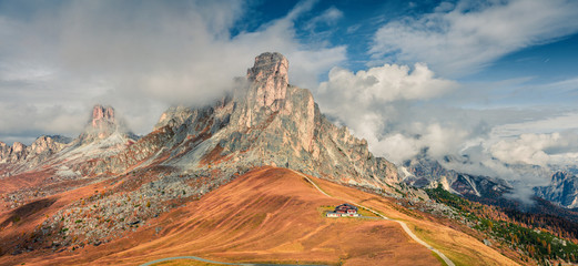 Foggy morning panorama from the top of Giau pass with famous Ra Gusela, Nuvolau peaks in...