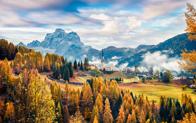 Foggy autumn view of Parrocchia Di Selva Cadore church. Great morning scene of Dolomite Alps,...