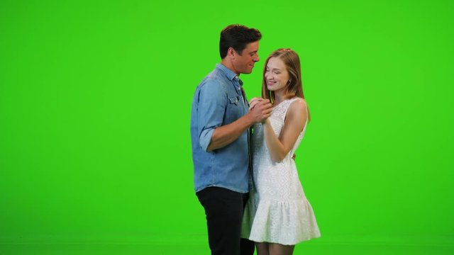 A in love man and a woman slow dancing, relaxed. Over a green screen.