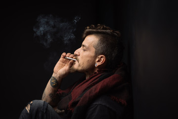 details of a man smoking a cigarette