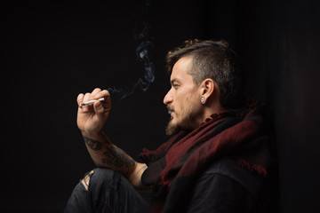 details of a man smoking a cigarette