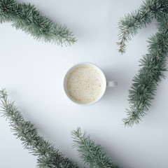 Winter Christmas table layout with coffee cup on pastel grey background. Minimal nature concept. Flat lay top view composition