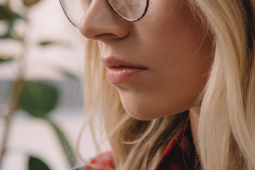 partial view of blond woman in eyeglasses