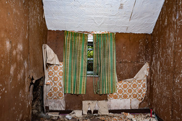 Creepy derelict bedroom window in an old abandoned house