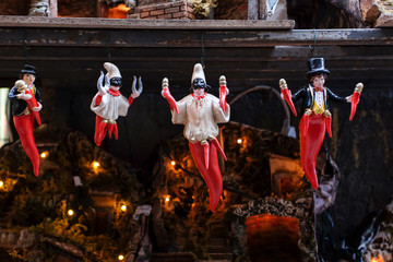 Statues of pulcinella lucky charm and red horns at the souvenir shop in Naples