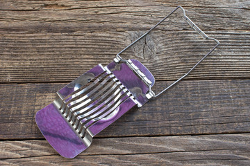 Egg slicer on wooden background