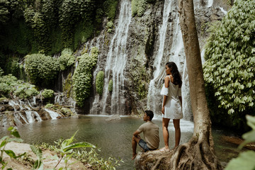 Fototapeta na wymiar couple looking at banyumala waterfall bali