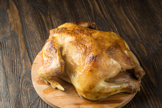 Roasted chicken on wooden background
