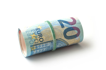 closeup of banknotes roll of twenty euros money on white background