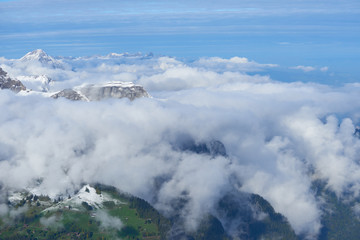 Winter mountain snowy peaks over the clouds in the valley. Jungfrau region in Switzerland.