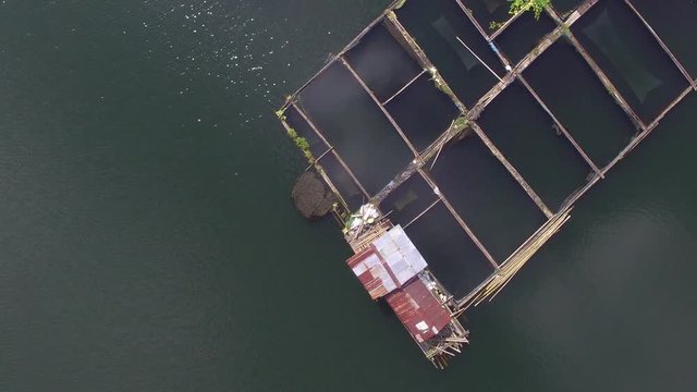 Sampaloc Lake, San Pablo City, Laguna, Philippines - November 21, 2017:  Bamboo fish cages built in the middle of mountain lake. Drone aerial shot