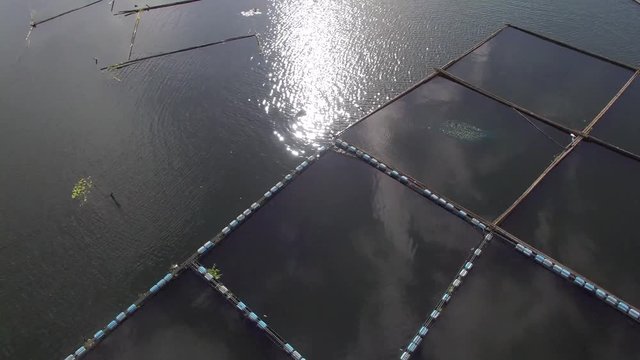 Sampaloc Lake, San Pablo City, Laguna, Philippines - November 21, 2017:  Bamboo fish cages built in the middle of mountain lake. Drone aerial shot