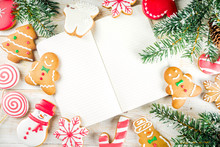 Christmas cookies with festive decoration on white wooden background top view copy space