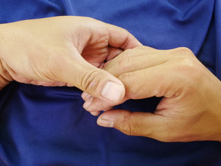 women hand on blue cloth background,texture of silk fabric