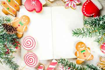 Christmas cookies with festive decoration on white wooden background top view copy space