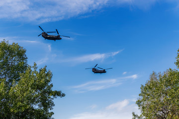 Greek Air Force Chinook helicopters flying. 
2 Boeing CH-47 Chinook twin engined lift helicopters at 28 October military parade, to commemorate Greek no on Italian 1940 ultimatum.