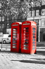 black and white photo with red telephone booth at London city United Kingdom