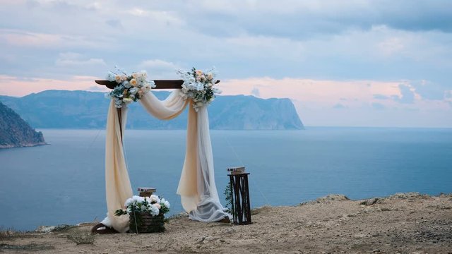 The wedding arch stands on the edge of the mountain near the sea.