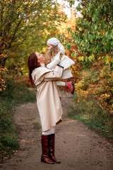 charming beautiful mother walks with little daughter girl