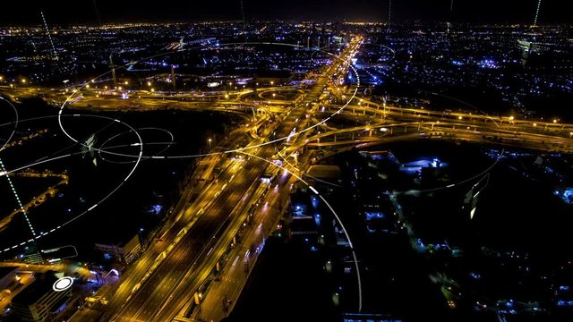 Futuristic digital broadcasting, gps location signals and data connectivity in the cityscape and expressway at night time time lapse