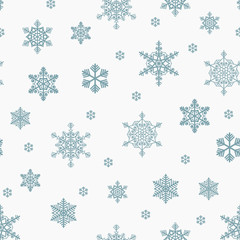 Seamless blue scattered snowflakes pattern on a white background.