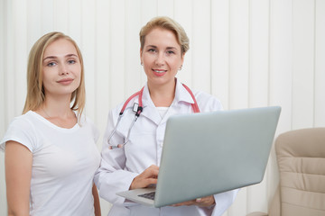 Female patient and doctor posing together.