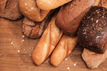 Fragrant bread on the table. Food concept on wooden cutting board