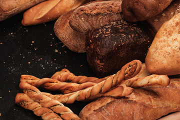 Fragrant bread on the table. Food on black background