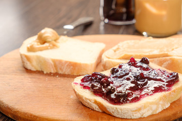 peanut butter sandwich with jam on cutting board