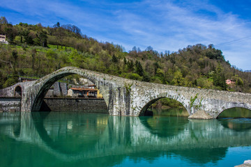 Fototapeta na wymiar Ponte della Maddalena or Ponte del Diavolo - Devil's Bridge in Borgo a Mozzano, Tuscany, Italy