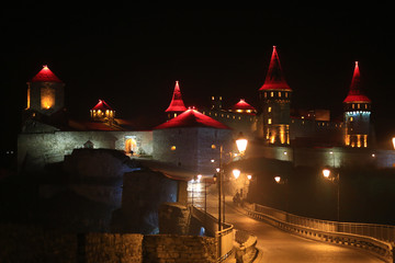 Old castle at night, stone fortress in Kamianets-Podilskyi city, western Ukraine