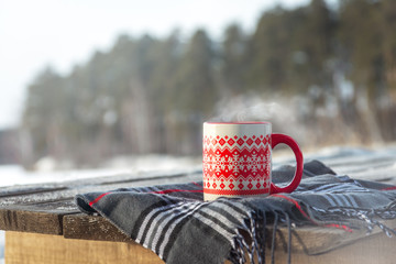Steaming cup with hot drink outdoor