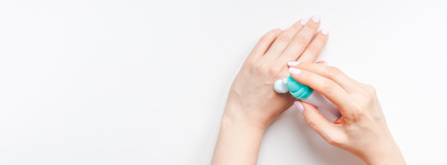 Woman moisturizing her hands with foam lotion