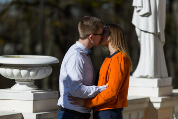 Romantic young couple kissing in the manor house background