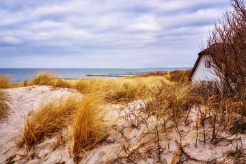 Panorama of the sand dune with house and view of the Baltic Sea.
