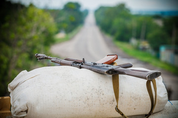 Assault rifle lying on a sandbag