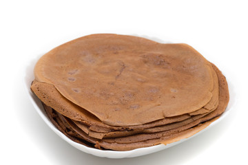 Chocolate pancake on a white plate