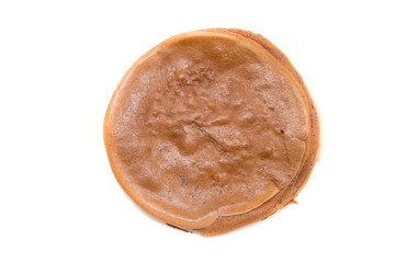 Chocolate pancake on a white plate - top view