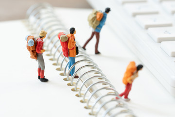 Miniature 2 people stand on The walkway the beginning of the journey To reach the goal. using as background  travel concept with copy spaces for your