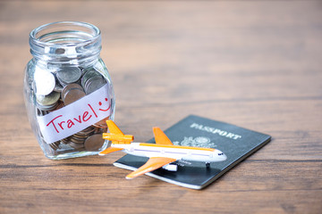 Saving money for travel, Money money coin in the glass jar and passport on the table