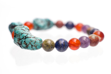 Turquoise, Unakite, lapis lazuli, Carnelian and Amethyst  bracelet isolated on white background.