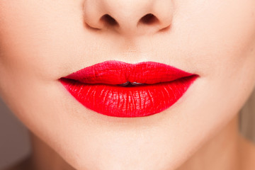 Obraz premium Beautiful women's lips with bright red lipstick, bright stylish makeup,
