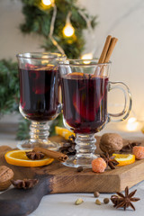 Mulled wine in glass on wood board at white background