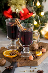 Christmas red mulled wine in glass on wood board at white background