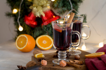 Christmas red mulled wine in glass on wood board at white background